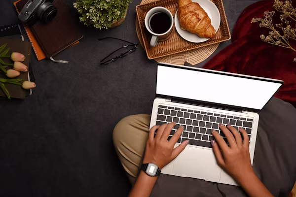 A freelancer reviewing their Upwork profile and proposal on a laptop, ready to send their first client pitch